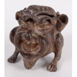 A cast iron inkwell in the form of a gargoyle, with glass liner, height 7.5cm, width 6.5cm, depth 8.