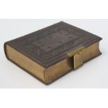 A leather bound Holy Bible, with brass clasp, containing the old and new testaments,