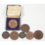 Seven bronze medals, some with boxes.
