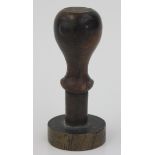 A bronze seal, with a turned wood handle, 19th century, the circular base with a coat of arms,