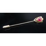 A 10ct gold stick pin set a heart shaped synthetic ruby.