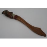 A treen paper knife, the handle in the form of a firemans head, length 29.5cm.