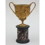 A gilt bronze twin handled cup, late 19th century, decorated with classical scenes,