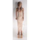 A carved wood and painted figure of a semi nude Egyptian lady,