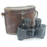 A pair of Hunsicker & Alexis, Paris military binoculars, in a brown leather case.
