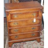A George III style walnut batchelors chest, the hinged top above four long drawers on bracket feet,