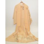 A Japanese pale orange silk kimono, decorated with flowers and foliage, length 158cm.