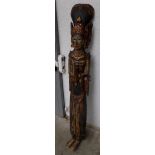 An Indonesian gilt and painted carved wood female figure, 20th century, height 151cm, width 23.5cm.