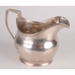 An Exeter silver plain bellied helmet milk jug with reeded rim and handle by William Welch of
