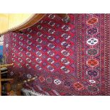 A Pakistan carpet, the madder field with seventeen rows of six medallions,