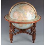 A 12" terrestrial table globe on stand, published 1886, cartouche printed 12 INCH GLOBE BY W & A. K.