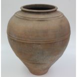 A large earthenware olive oil jar, height 49cm, diameter 44cm.