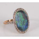 An opal and diamond oval cluster ring.