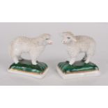 A pair of porcelain models of sheep, 19th century, each with a gold anchor mark to the underside,