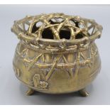 A pair of Chinese polished bronze censers each with a pierced cover in the form of intertwined