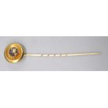 A Victorian high purity gold stick pin the finial with a bowl holding and an enamelled diamond set