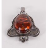 A silver and amber Art Nouveau style pendant.