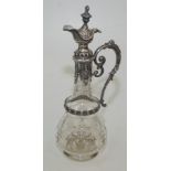 A German silver mounted claret jug with engraved decoration, height 36cm.