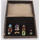 An early 20th century box to hold twenty-four rings, in it are eleven gold and other rings.
