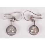 A pair of white gold or platinum earrings each with an old cut diamond set drop.