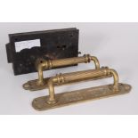 A pair of brass door handles and plates, decorated with stylised plants, length 34cm,