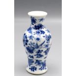 A Chinese blue and white baluster vase decorated with floral sprays and birds in flight,