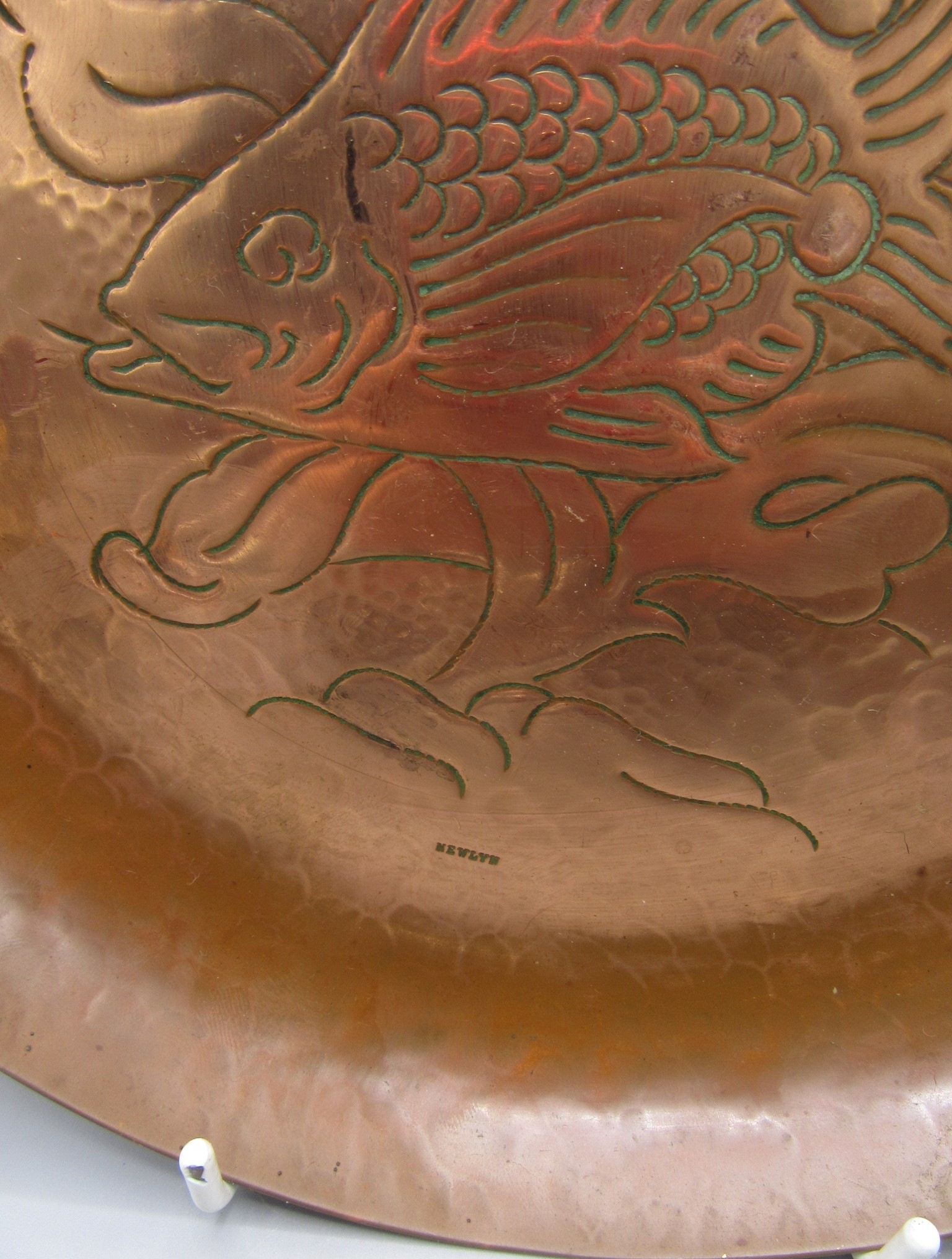 A Newlyn copper circular tray, decorated with a stylised fish amongst seaweed, impressed mark, - Image 2 of 2