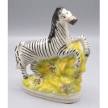 A Victorian Staffordshire figure of a zebra, height 16cm, width 13cm.