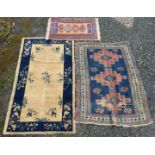 A Caucasian rug, the indigo field with three madder stepped medallions, within three borders,