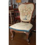 A Victorian walnut salon chair, with a needlepoint covered back and seat on cabriole supports,