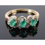 A 9ct gold triple emerald serpentine set ring.