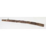 A wooden didgeridoo carved with a snake, length 131cm.
