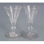A pair of wine glasses, 19th century, with etched decoration, height 11.5cm.