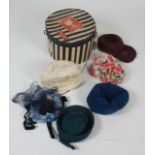 Six vintage hats in a cardboard hat box.