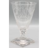 A Masonic etched glass goblet, decorated with numerous symbols on a square foot, height 15.