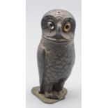 A pewter pepper pot in the form of an owl, early 20th century, with glass eyes, height 8cm.