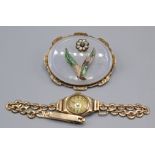 A Victorian gold mounted brooch and a ladies gold cased wristwatch on 9ct gold bracelet.
