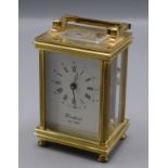A gilt metal carriage clock, 20th century, the rectangular white dial inscribed 'Woodford Est.