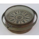 A brass ships compass, total diameter 26cm, height 10.5cm.