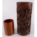A Chinese carved bamboo brush pot, decorated with figures in pagodas beneath trees,