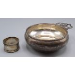 A porringer by William Comyns with pierced handle, London 1898, together with a silver napkin ring,