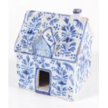 A Delft pottery blue and white model of a cottage, signed to the base, height 10cm, width 7.