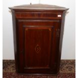 A George III mahogany corner cupboard,