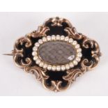A Victorian high purity gold mourning brooch with an oval of plaited hair,