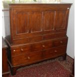 A George III oak mule chest, with a quadruple panelled fall front flanked by canted corners,
