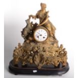 A French gilt metal mantel clock, 19th century, surmounted by a shepherdess and her sheep,