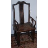 A Chinese hardwood armchair, 19th century, the humpback top rail above a vertical solid splat,