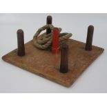 A Slazenger quoits board with five pegs and four rope rings, 36 x 36cm.
