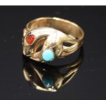A 9ct gold double snake ring the heads set turquoise and garnet.