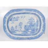 A blue and white willow pattern meat dish, 19th century, impressed 20 to the underside, 39 x 53cm.